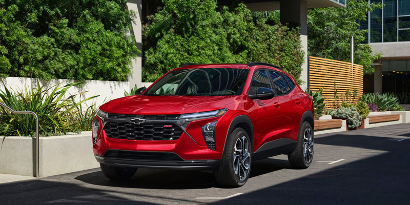 2026 Chevrolet Trax red SUV parked confidently, highlighting its bold exterior styling, sharp character lines, and modern compact design.